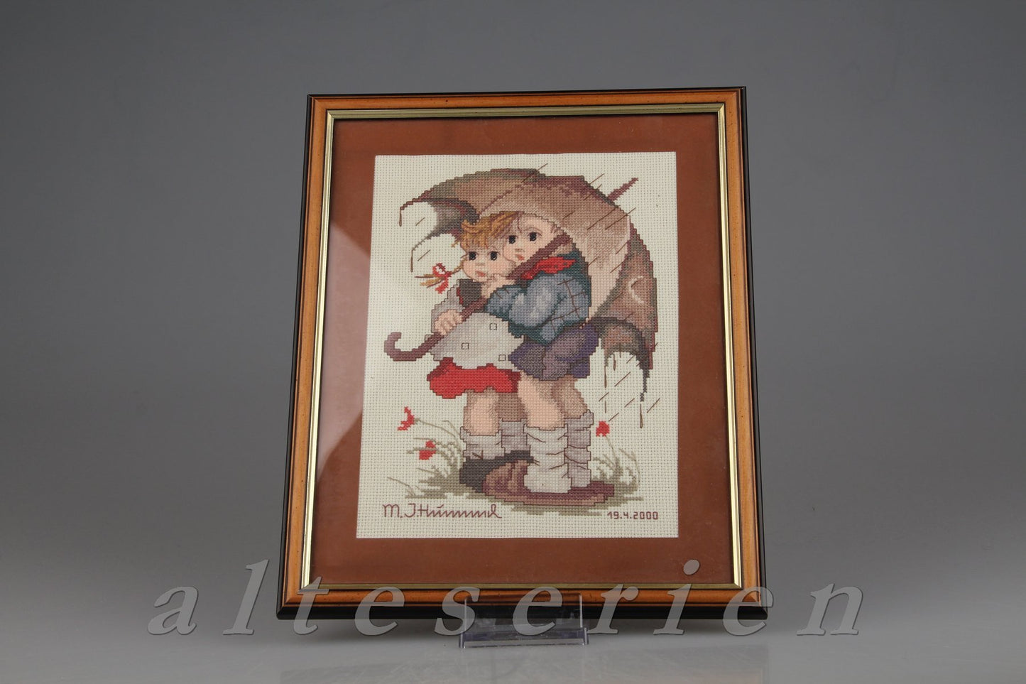 Stickbild im Holzrahmen Kinder unterm Schirm